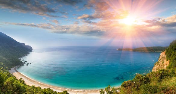 Photo of panoramic landscape of the rocky coastline sea and Jaz Beach at sunshine, Budva, Montenegro.