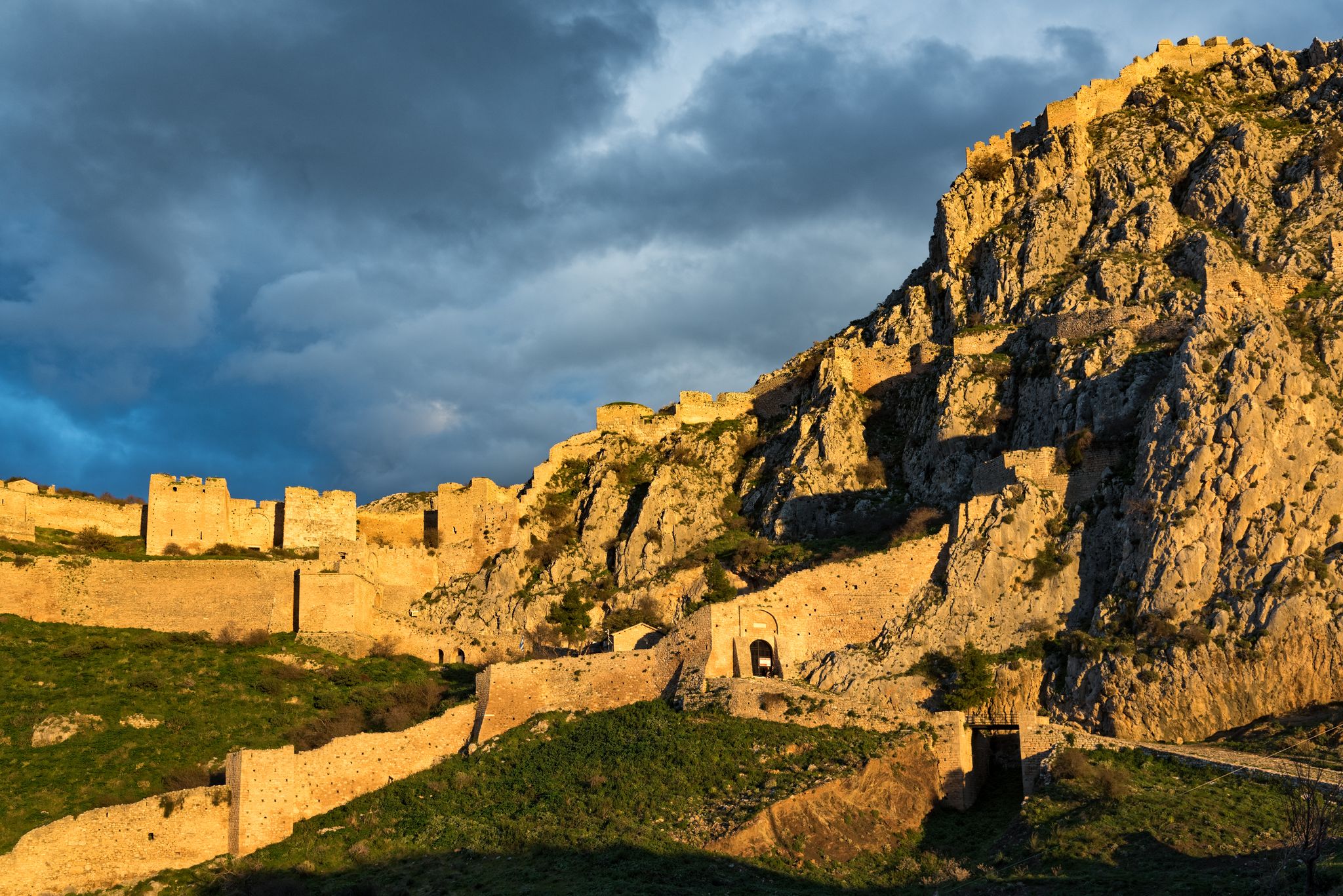 photo of View of the archaeological site of Acrocorinth, the acropolis of ancient Corinth in Peloponnese, Greece at sunset, Corinth. Greece.