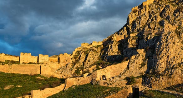 photo of View of the archaeological site of Acrocorinth, the acropolis of ancient Corinth in Peloponnese, Greece at sunset, Corinth. Greece.