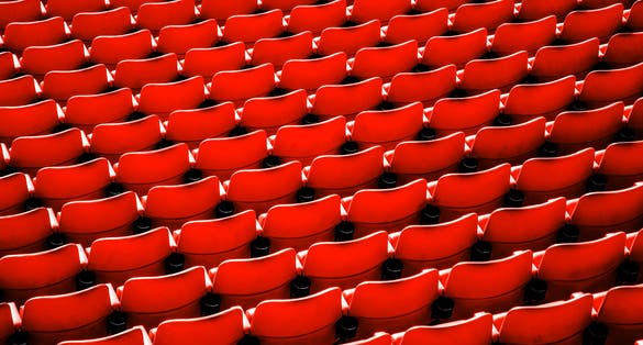 Photo of red seats in Wembley Stadium that is a football stadium in Wembley, UK.