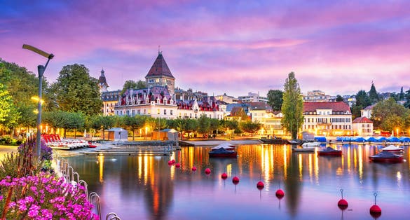 Photo of Lausanne from the Ouchy Promenade on Lake Leman at twilight, Switzerland.