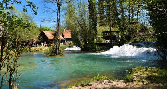 photo of view of View of Korana river flowing through the town of Slunj in Karlovac county, Croatia in summer