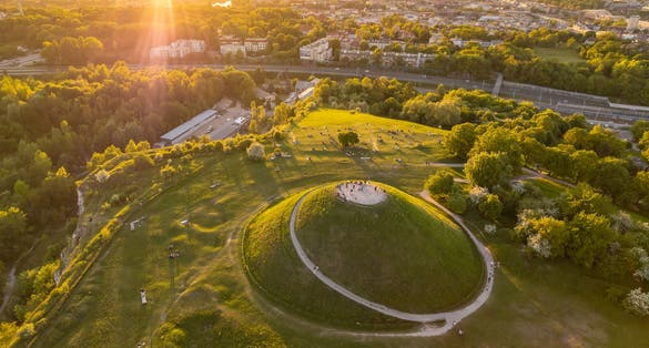 Aerial summer view of the Krakus Mound with amazing sunset view of the historical part of Krakow old town, Poland. Popular place to watch sunset in Cracow.