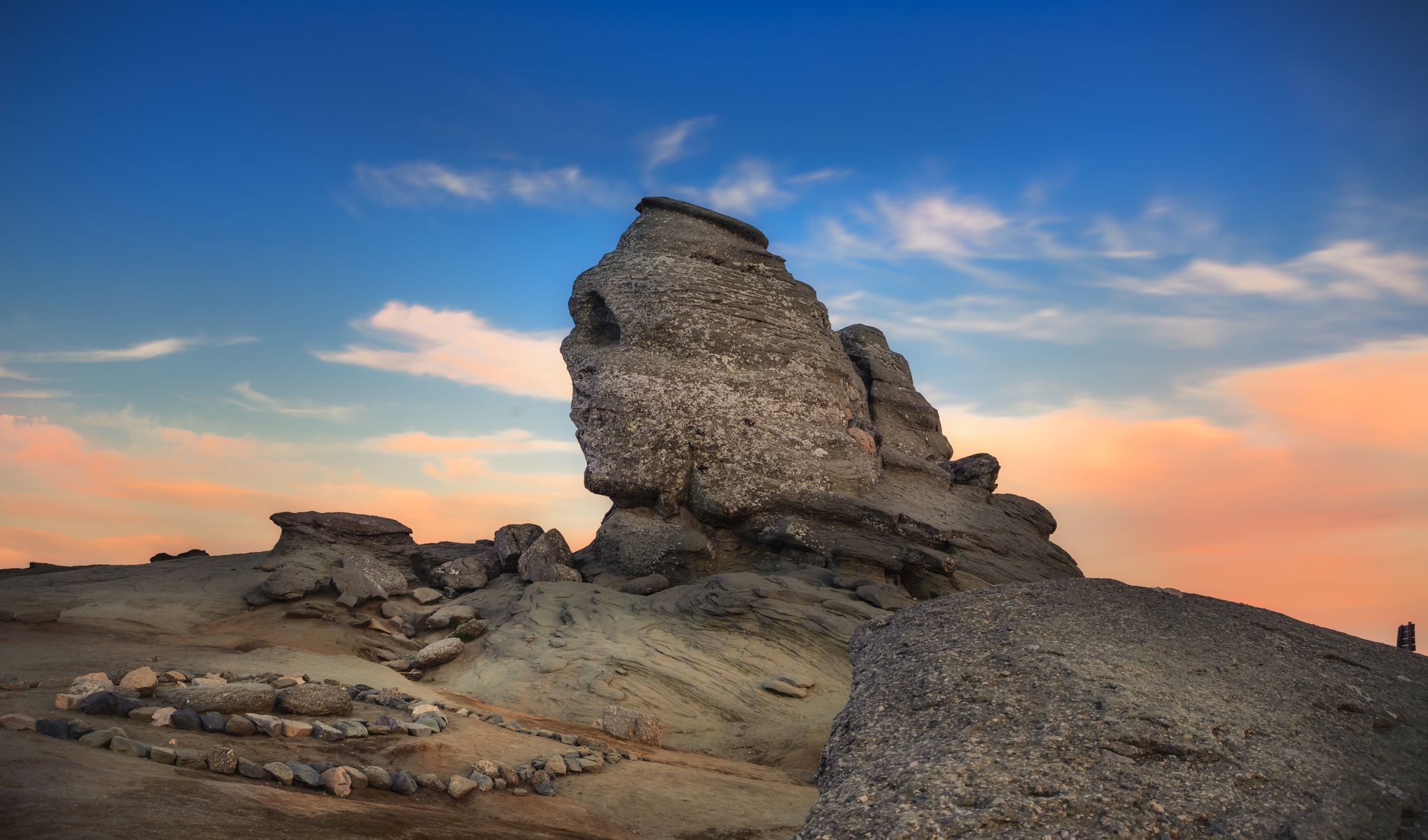 Photo of Sunset at Romanian Sphinx, natural rock formation and geological phenomenon formed through erosion in Bucegi Natural Park, Carpathian Mountains, Romania.