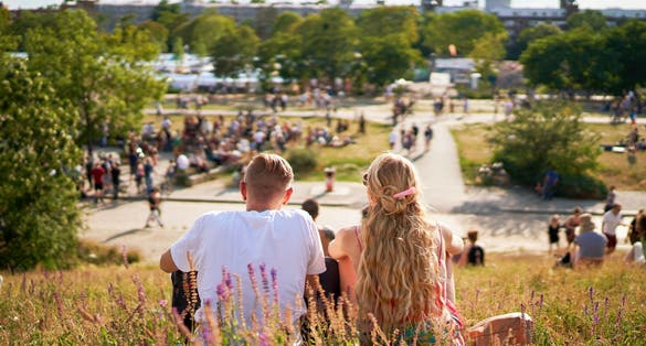 photo of people in park blurry in crowded Park (Mauerpark) on a sunny summer Sunday in Berlin, Germany.