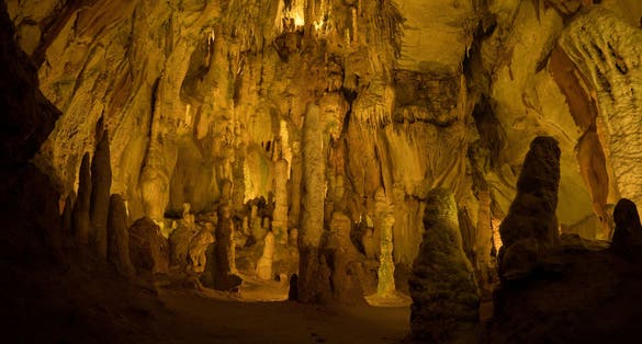 Illuminated lit lights stalagmites stalactites limestone show cave cavern Grutas da Moeda in Batalha Leiria Portugal