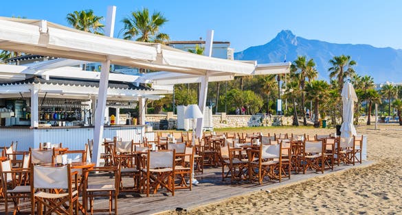 Bar on beautiful beach in Marbella town near Puerto Banus marina, Costa del Sol, Spain