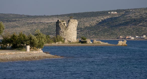 Photo of Večka kula tower and the blue coast, Croatia.
