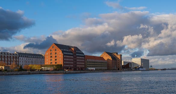 Photo of aerial view of Cultural centre North Atlantic House and buildings on the Kroyers Plads or Larsens Plads on harbour of Copenhagen canal, Denmark.