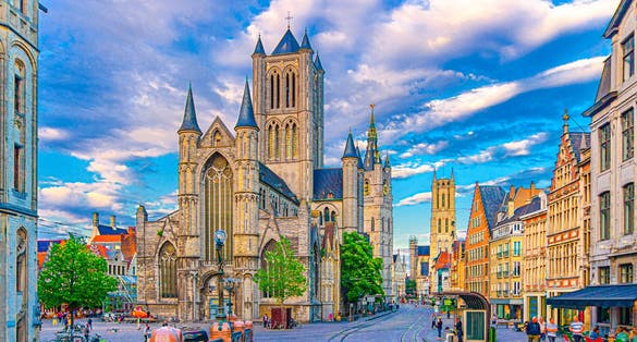 Ghent city historical center with Saint Nicholas Church on Korenmarkt Wheat Market square, Belfry Het Belfort van Gent and row of colorful buildings, East Flanders province, Flemish Region, Belgium