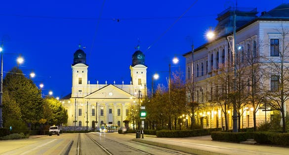 photo of view of Reformed Great Church in Debrecen city at night, Hungary.