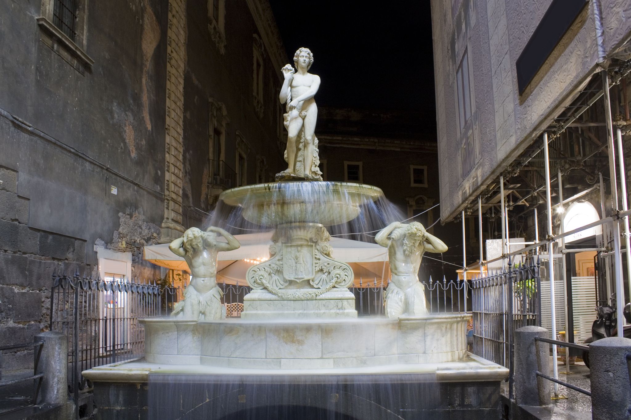 photo of Amenano fountain at evening in Catania, Italy, Sicily .