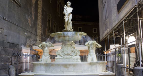photo of Amenano fountain at evening in Catania, Italy, Sicily .