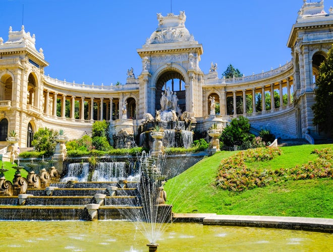 Palais Longchamp in Marseille, France, with cascading fountains, classical architecture, and landscaped gardens on a sunny day..jpg