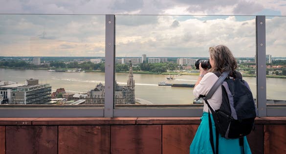 Photo of tourist taking pictures on the roof of the MAS (Museum aan de Stroom). It is a museum located along the river Scheldt in the Eilandje district of Antwerp, Belgium.