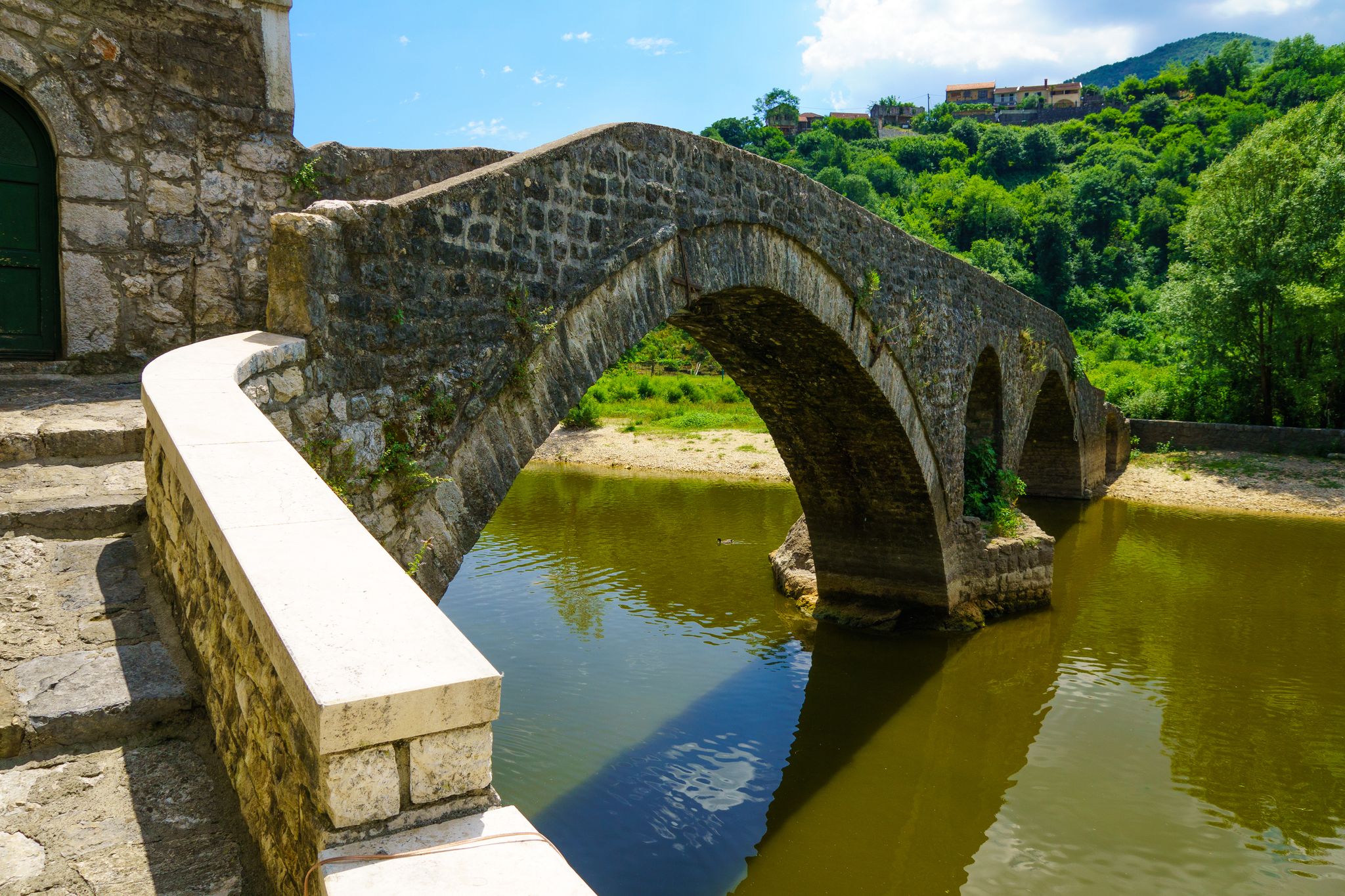 Photo of the old arched stone bridge of Rijeka Crnojevica on Montenegro.