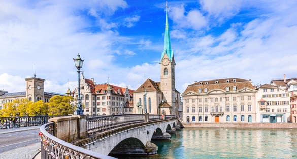 photo of morning view of Zurich, Switzerland. View of the historic city center with famous Fraumunster Church, on the Limmat river.