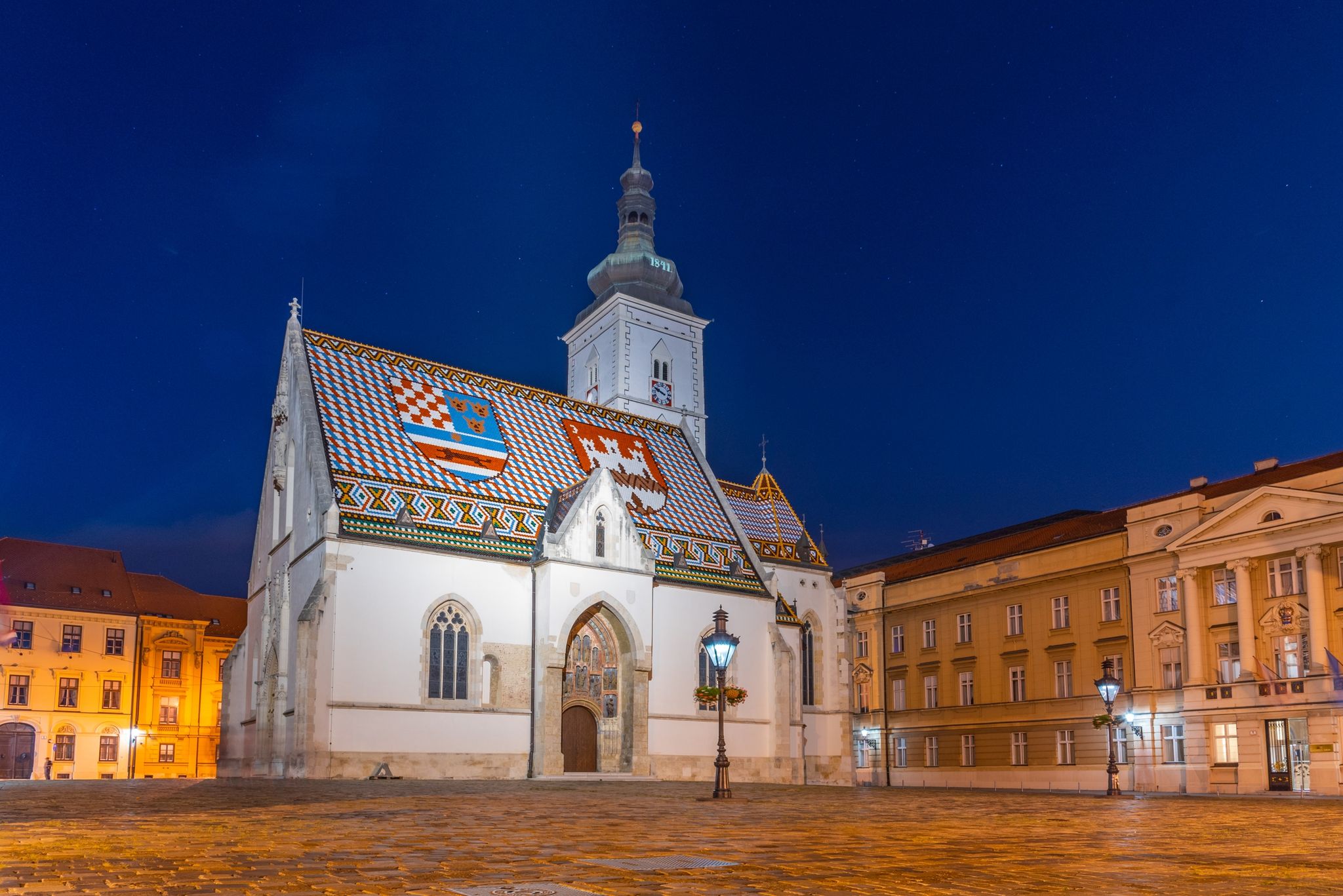 Photo of night view of the Church of St. Mark that is the parish church of old Zagreb, Croatia in St. Mark's Square.