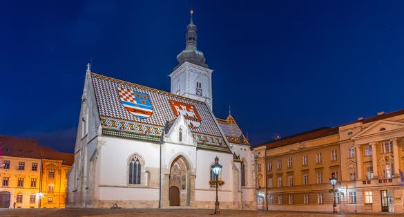 Photo of night view of the Church of St. Mark that is the parish church of old Zagreb, Croatia in St. Mark's Square.