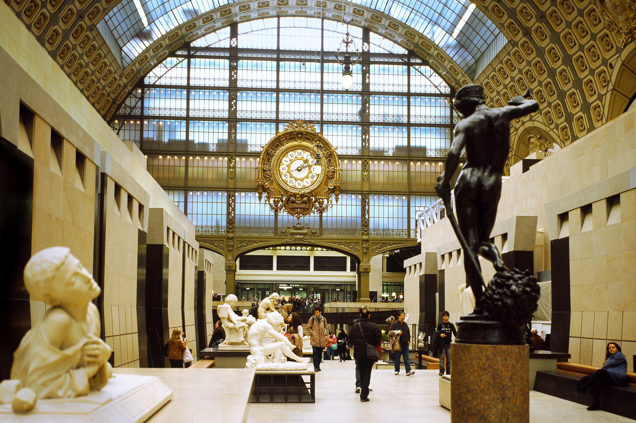 Photo of view from the central corridor, in the background the clock of the old railway station ,on the right the David of Antonin Mercié seen from behind, Musee d'Orsay, Paris, France.