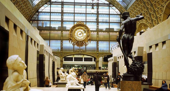 Photo of view from the central corridor, in the background the clock of the old railway station ,on the right the David of Antonin Mercié seen from behind, Musee d'Orsay, Paris, France.