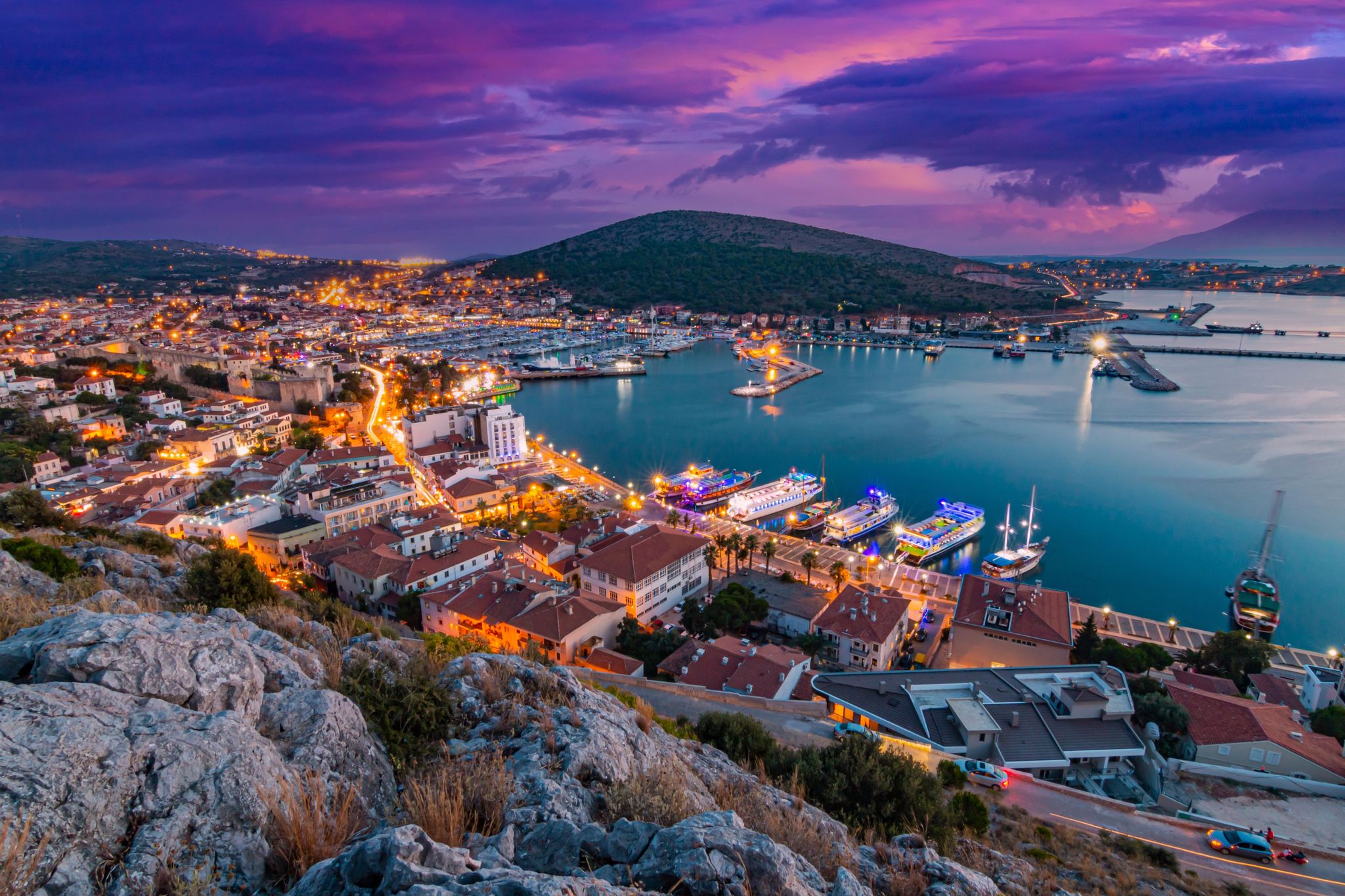 photo of night view of Cesme Marina, from Cesme Castle. Cesme is a coastal town in Izmir, Turkey.