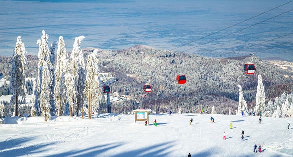Ski gondolas over the skiers on the ski slope, Poiana Brasov, Romania, Europe