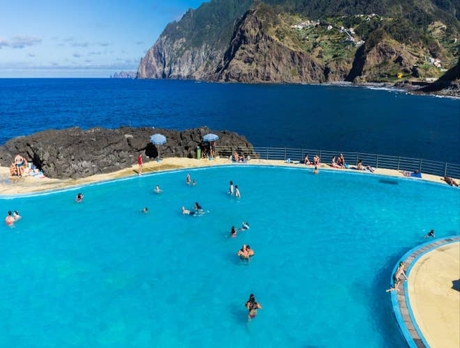 Travelers swimming in a natural ocean pool in Madeira, a refreshing escape in Portugal in August..jpg