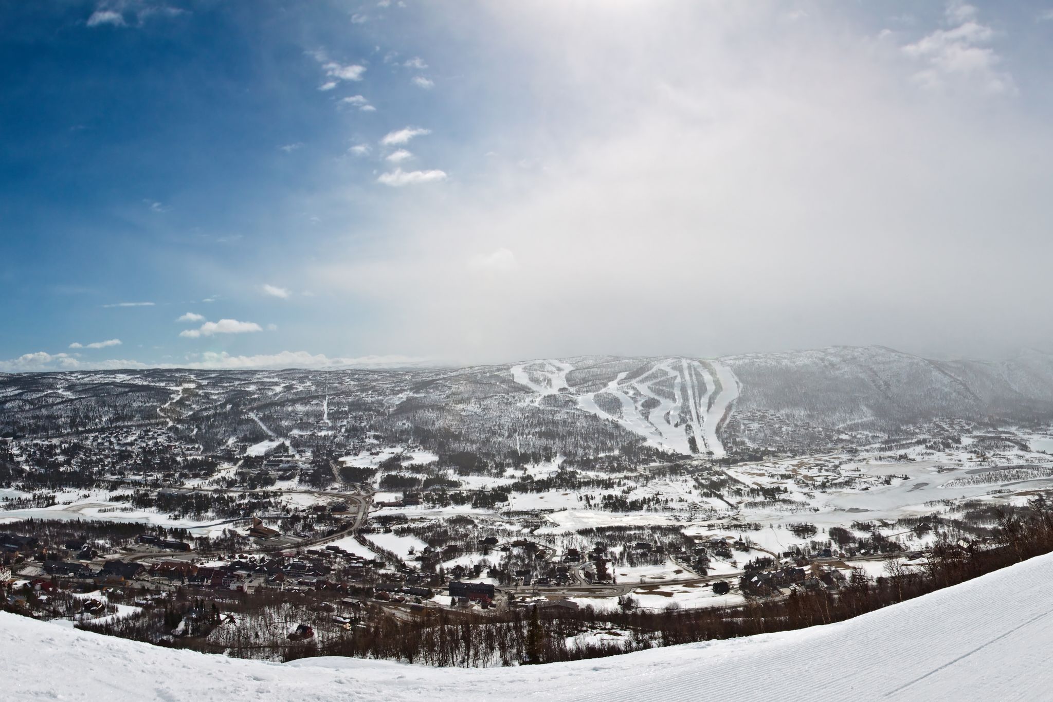 photo of panorama of ski resort with ski slopes and approaching snowstorm in Geilo, Norway.