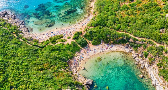Photo of iconic Corfu Island. Aerial view of Porto Timoni beach in Corfu, Ionian sea, Greece.