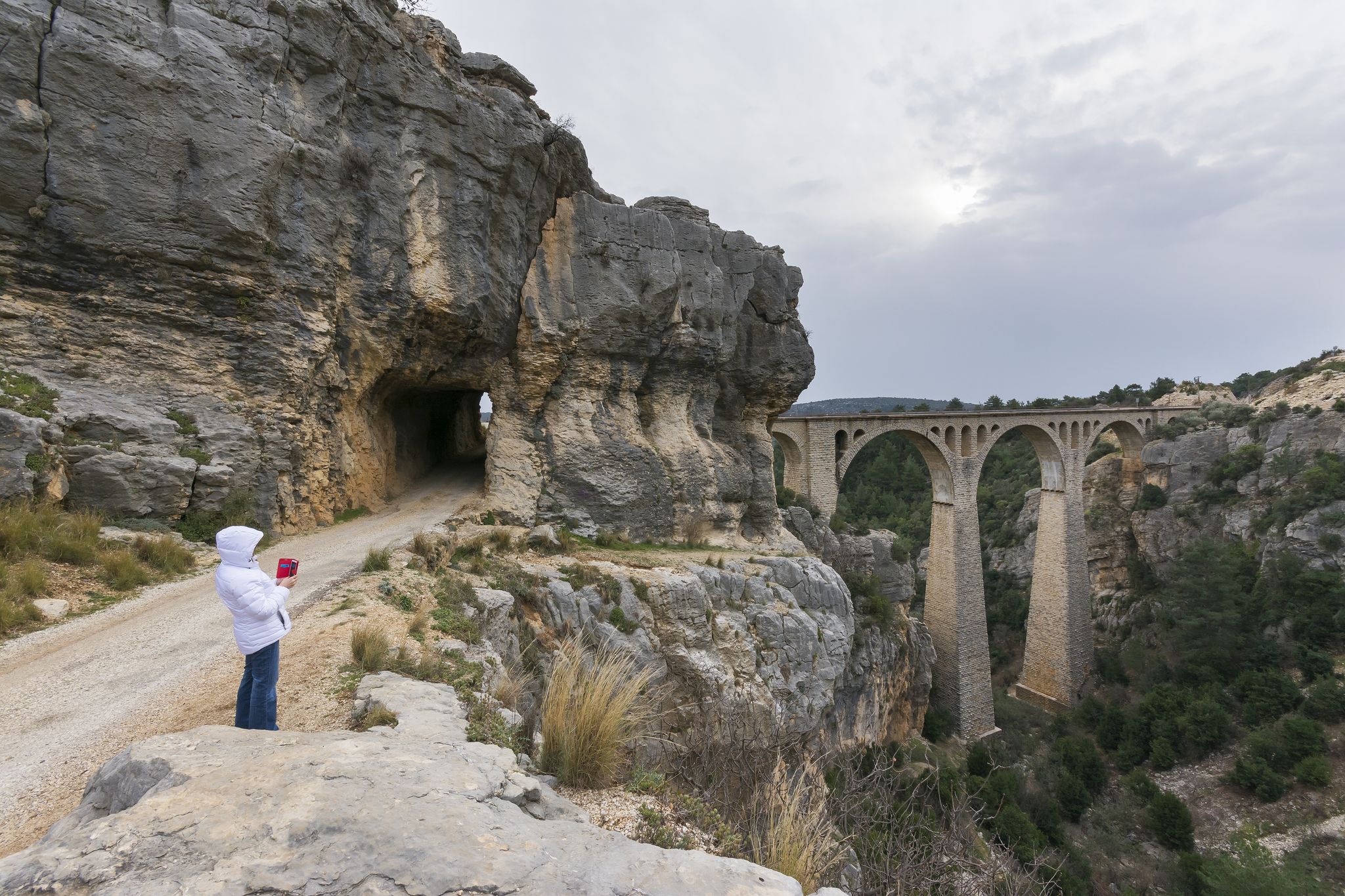photo of women is getting photo with mobile phone in Varda Bridge in Adana, Turkey.