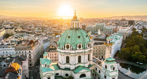 Photo of aerial drone view of St. Charles Church "Karlskirche" at sunset, Vienna, Austria.