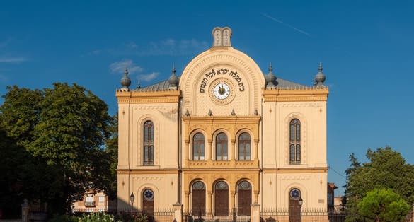 Pecs Synagogue in Hungary. The face of the synagogue is decorated with a clock and an inscription in Hebrew that reads, "For my house, be called to the house of prayer for all peoples."