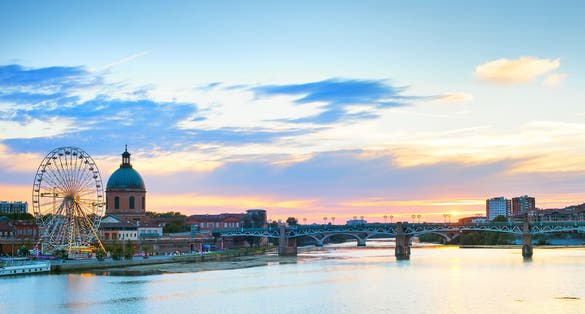 Photo of Toulouse landmarks on the bank of river Garone at sunset. France.