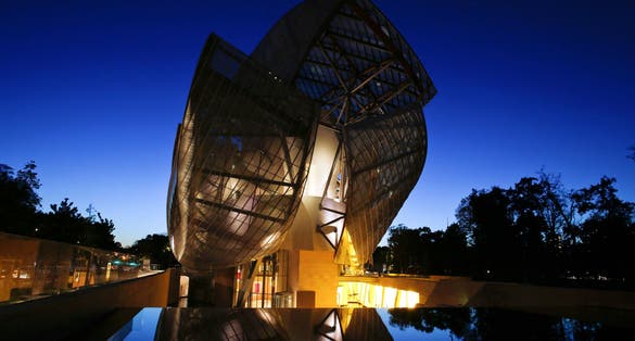 photo of Louis Vuitton Foundation at night in Paris, France.