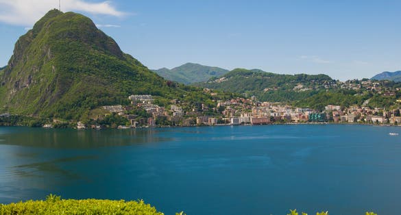 photo of Lake Lugano and Mount San Salvatore on a sunny summer day. Alpine mountain scenery in the city of Lugano, Switzerland.