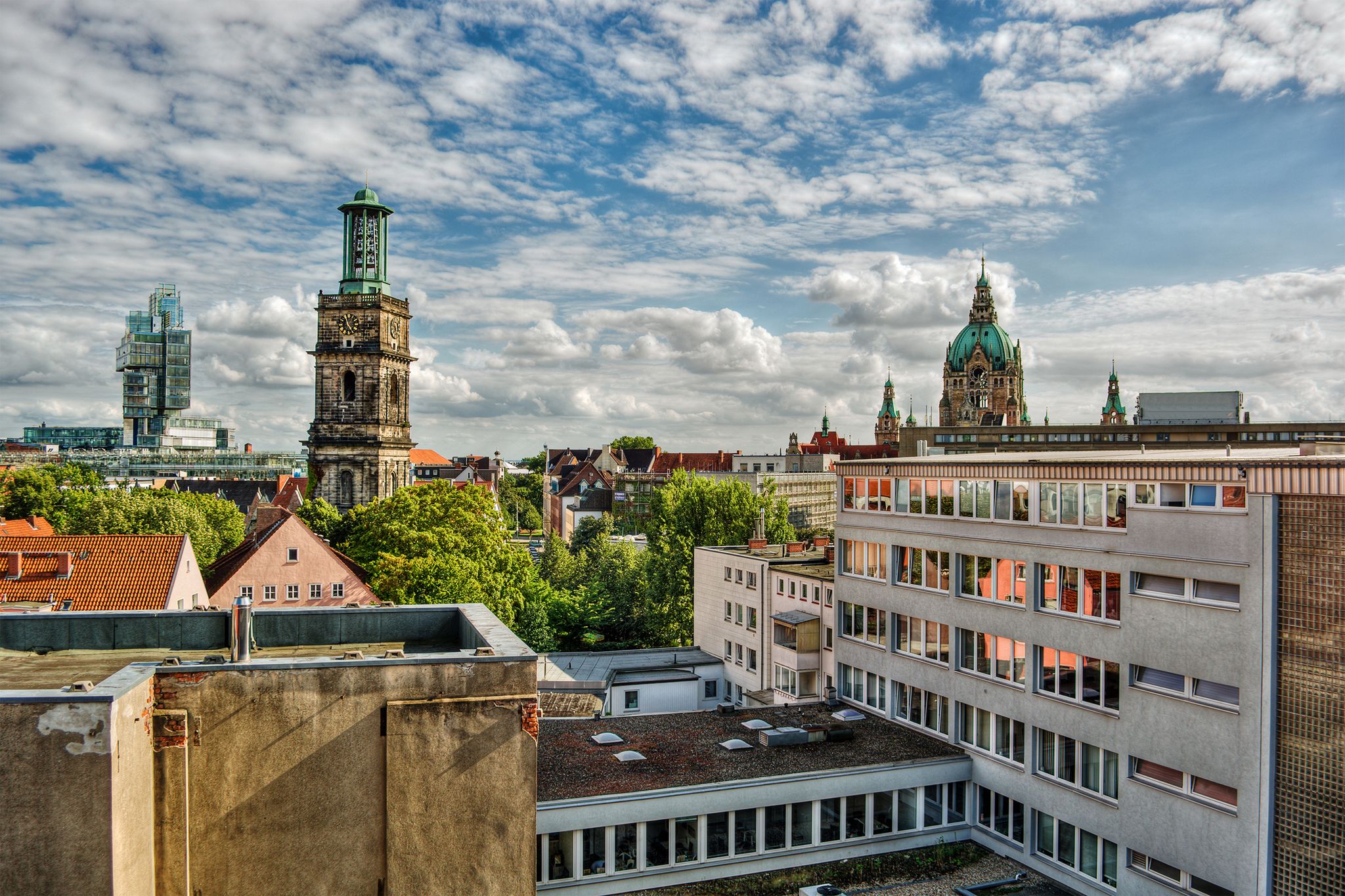 Cityscape of Hanover (Germany), including the modern building of a bank, the church Aegidienkirche and the town hall, HDR-technique