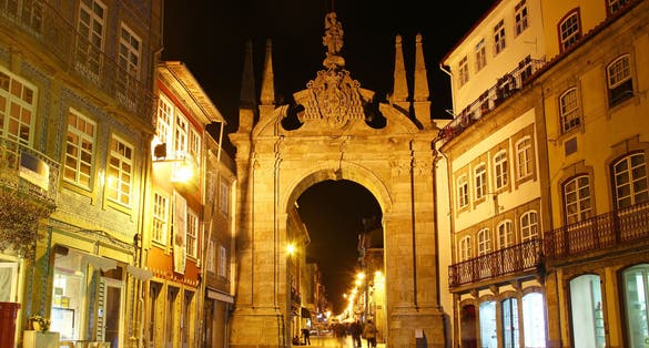 Photo of Arch of the New Gate (Arco da Porta Nova) and the entrance to the medieval wall of the city in Braga, Portugal.