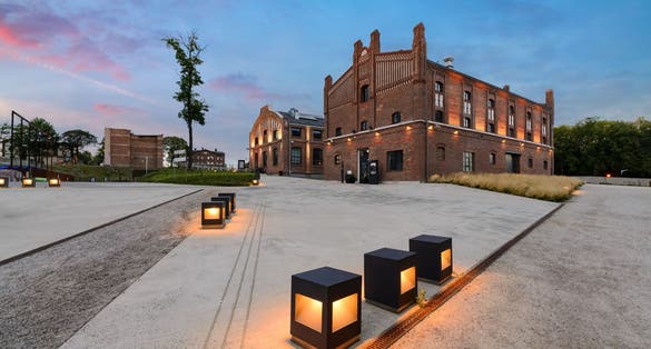 The former coal mine "Katowice", seat of the Silesian Museum. The complex combines old mining buildings and infrastructure with modern architecture. Poland. Europe. in the evening.