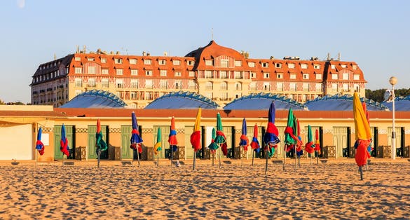 photo of view off Colorful umbrellas on the sand beach of Deauville, Normandy, France..