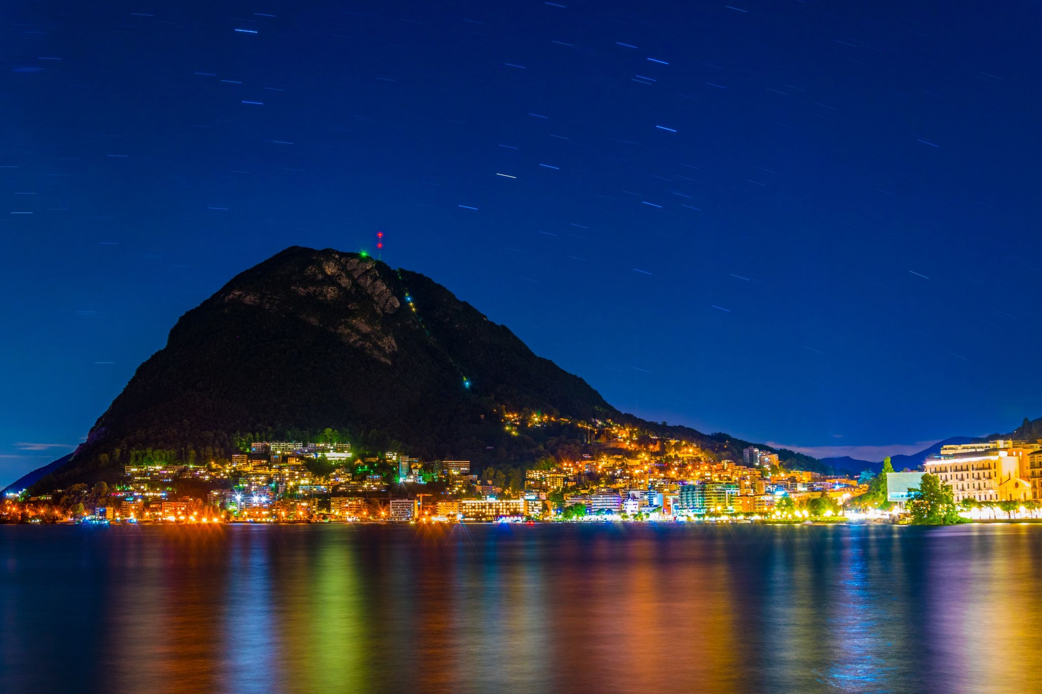 photo of night view of Monte San Salvatore in the city of Lugano in Switzerland.