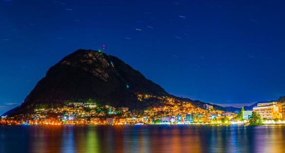 photo of night view of Monte San Salvatore in the city of Lugano in Switzerland.