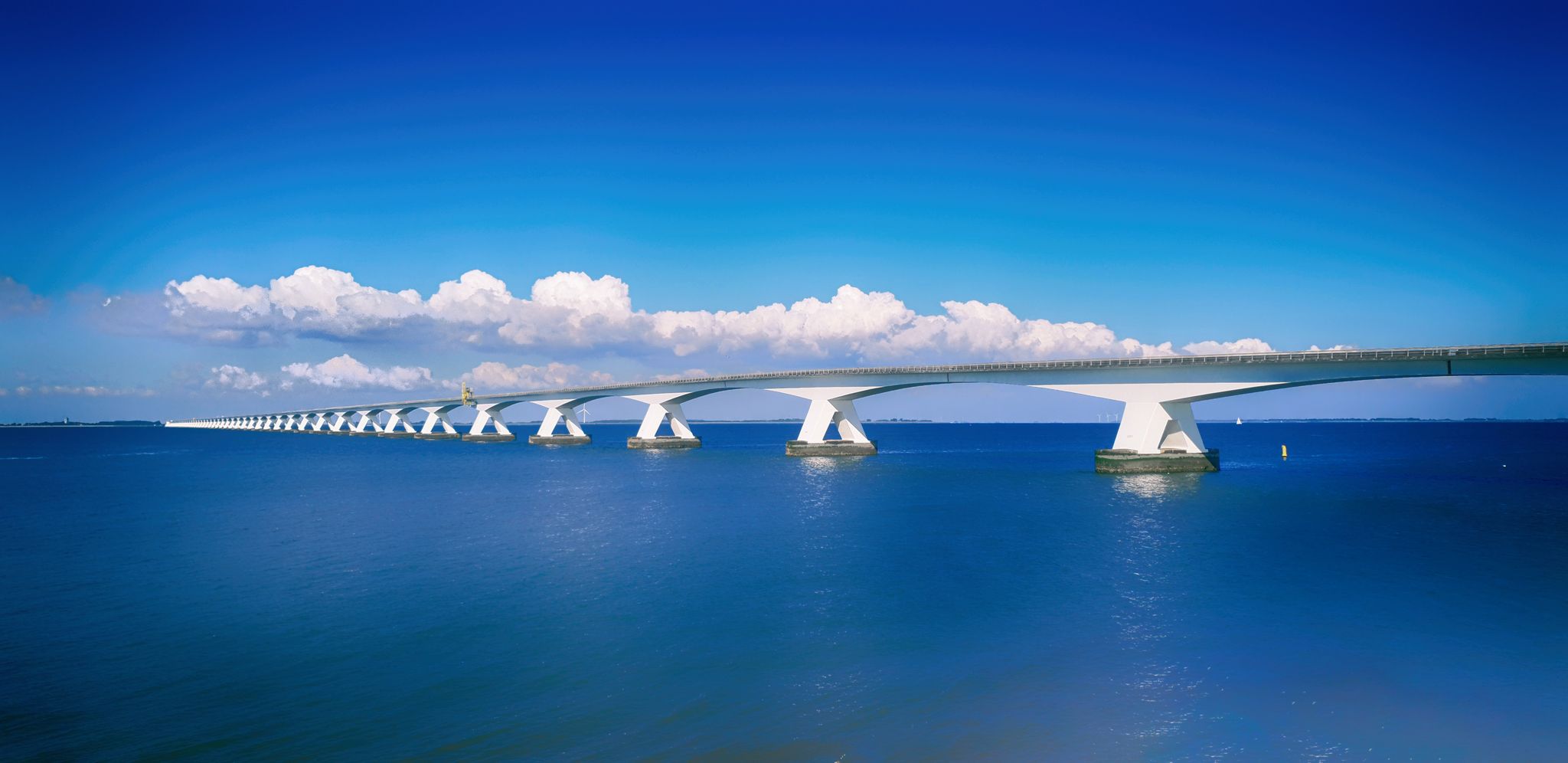 photo of a beautiful morning at Zeeland Bridge a long bridge over the blue sea in Zierikzee, the Netherlands.
