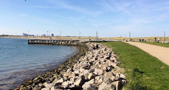 Photo of Amager Strandpark, with foreground rocks lit up by the morning light, Copenhagen, Denmark.