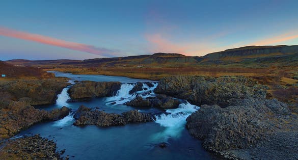 photo of Glanni Waterfall Iceland at sunset .