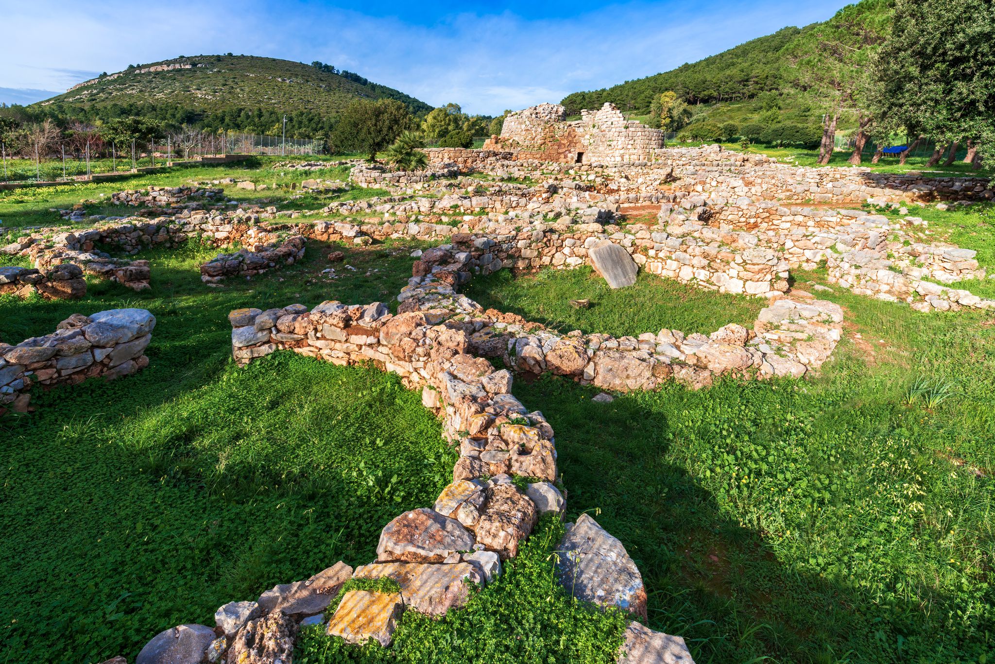 photo of view of Nuragic complex of Palmavera, archaeological site with stone ruins of a Nuragic settlement from the Bronze Age, Porto Conte, Alghero, Maristella, Italy.