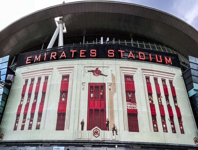 Emirates Stadium exterior featuring Arsenal-themed mural and red window designs..jpg
