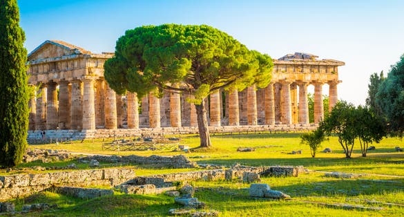 photo  of view of Beautiful view of famous Paestum Temples Archaeological UNESCO World Heritage Sitein in scenic golden evening light at sunset, Province of Salerno, Campania, Italy