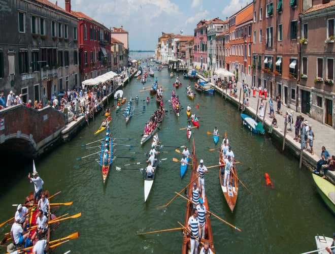 Traditional boat parade in Venice during a summer festival in Italy in June..jpg