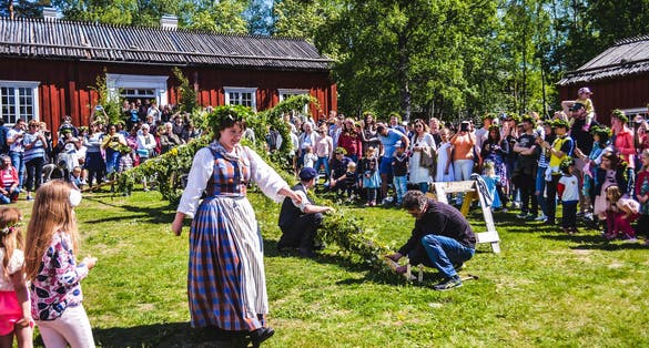Umea, Sweden, Happy people enjoy watching pole standing moment while a beautiful woman passing by.